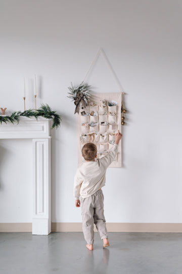 boy playing with a christmas advent calendar