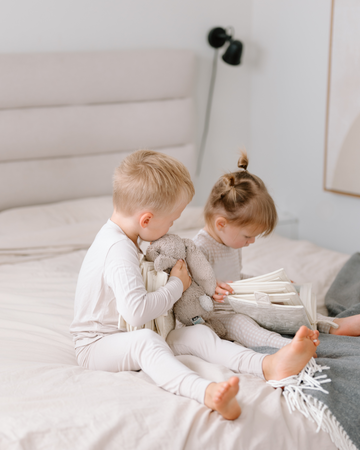 toddlers looking at a photo book